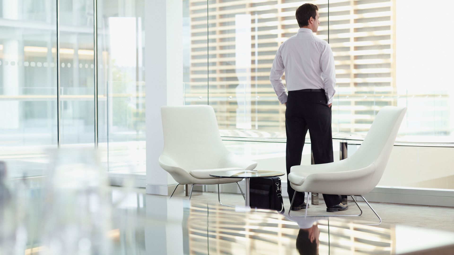 Man looking out office window