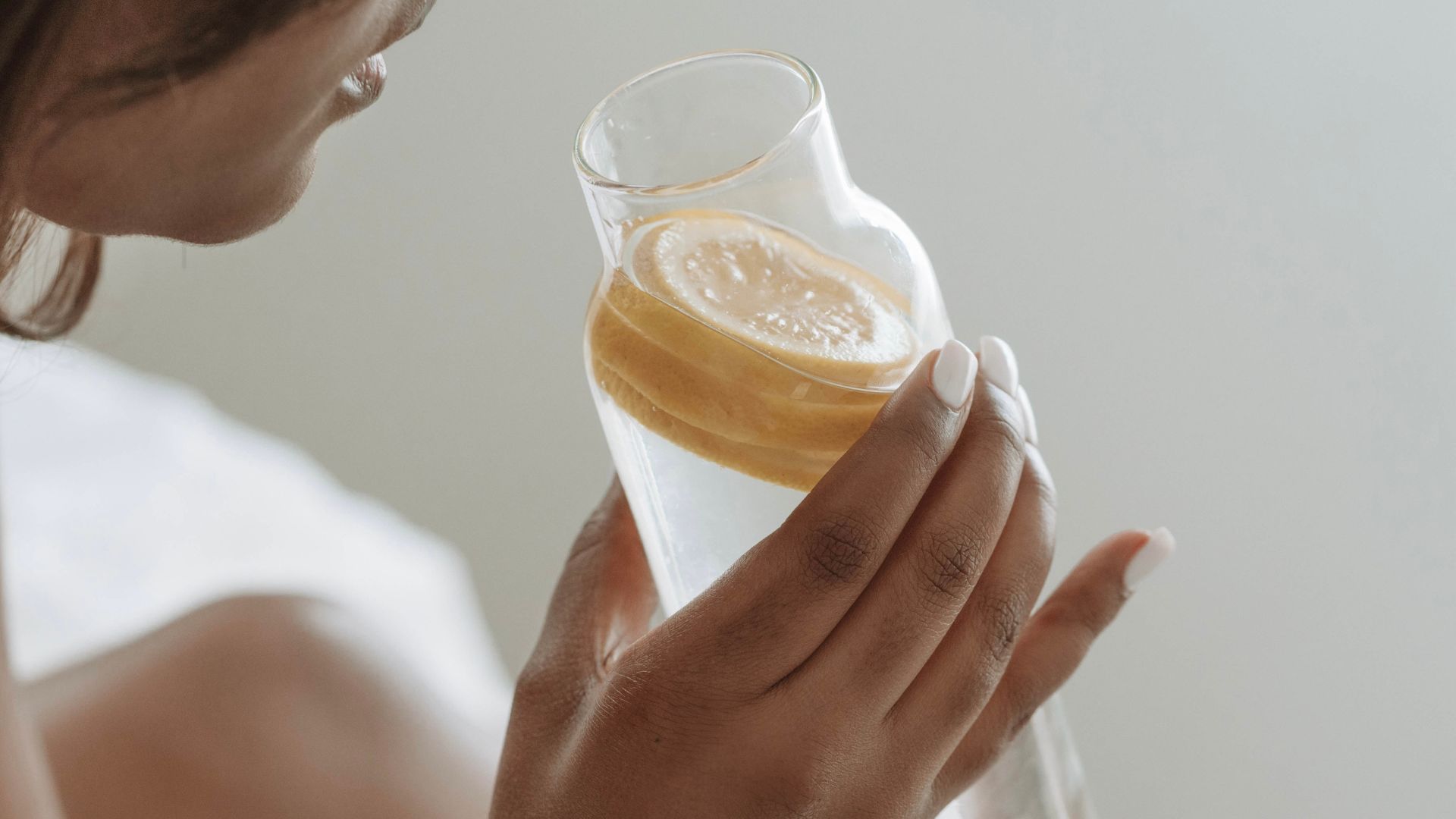 Woman drinking water with lemon