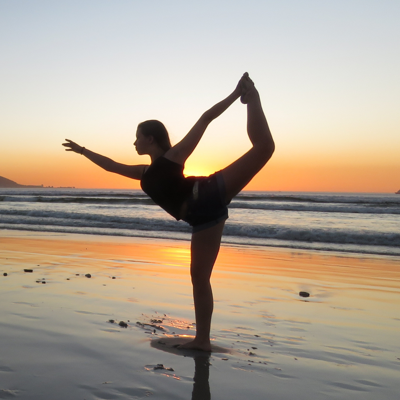 Silhouette of Woman Doing Yoga at the Beach