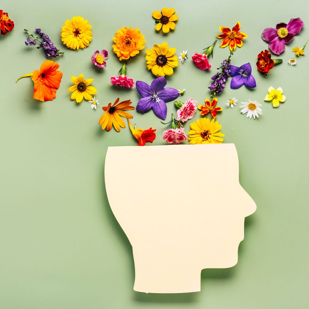 Human head symbol and flowers on blue background