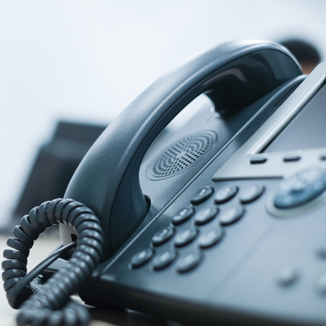 close up soft focus on telephone devices at office desk for customer service support concept