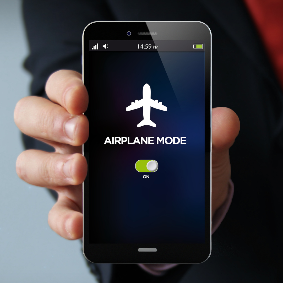 a woman holding a phone in an airplane mode