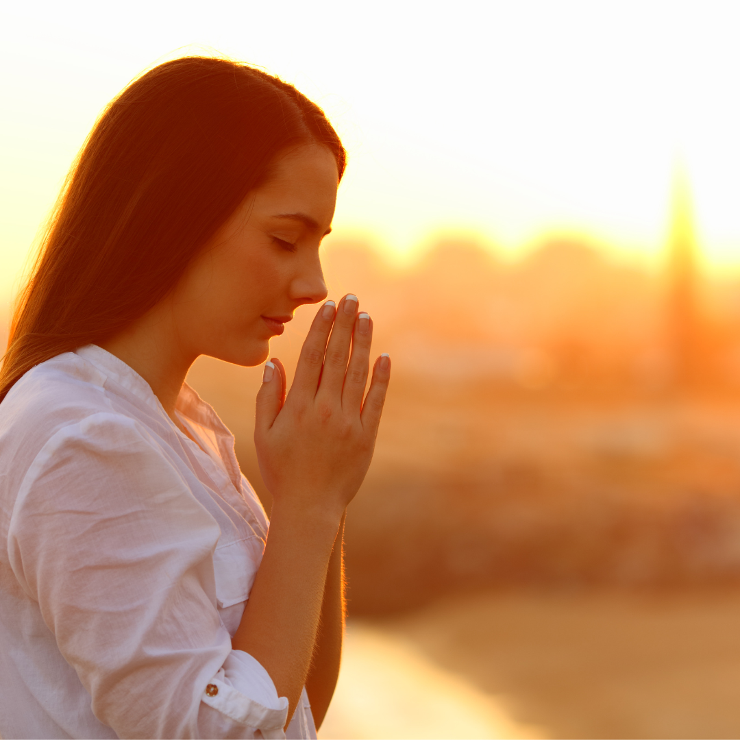 Profile of a concentrated woman praying at sunset