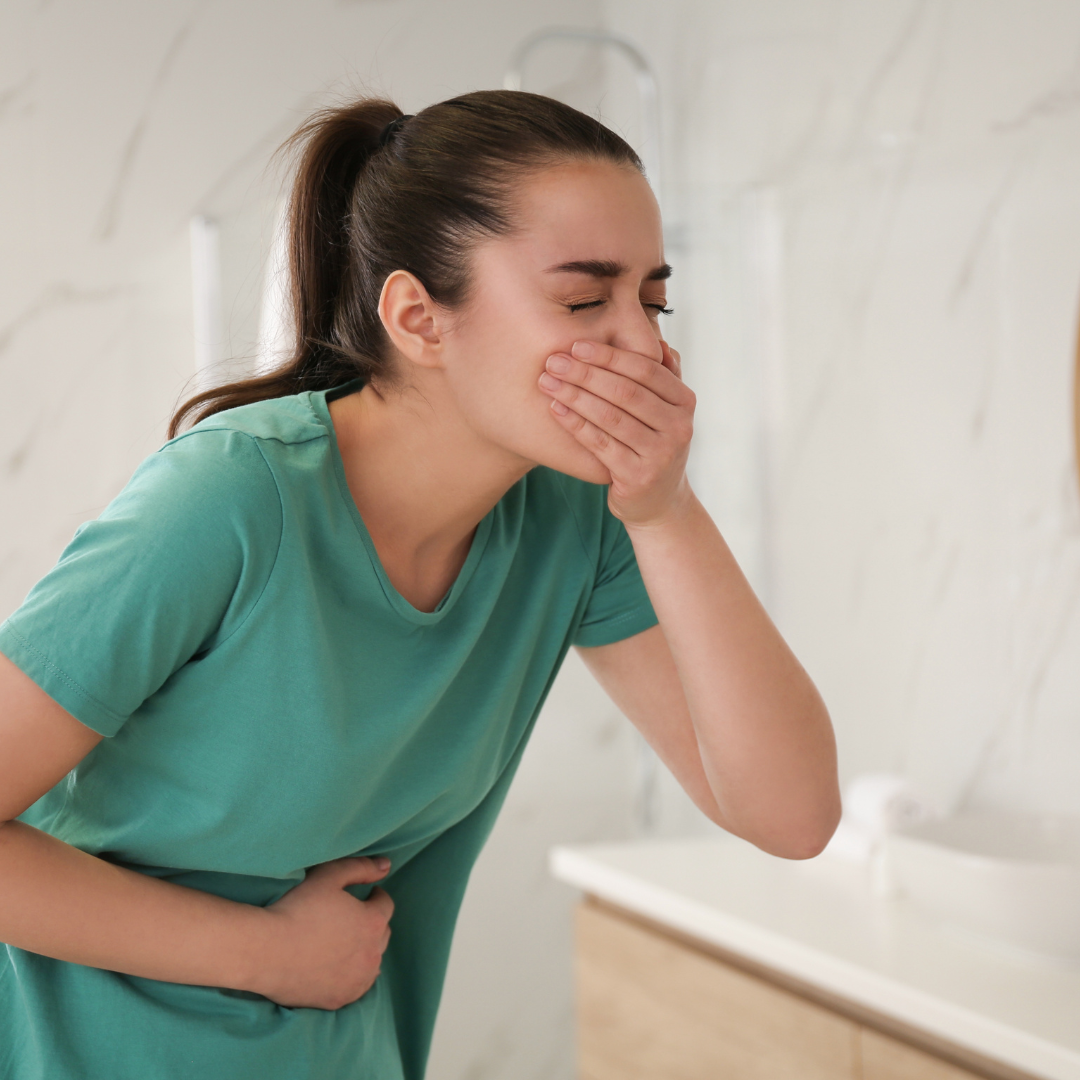 Young Woman Suffering from Nausea in Bathroom. Food Poisoning