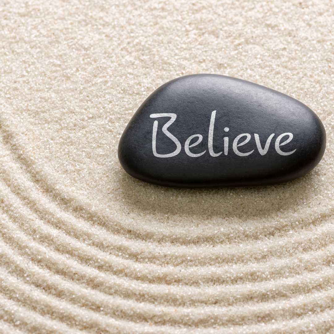Black stone with the inscription Believe