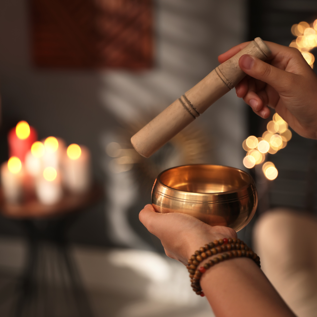 Healer Using Singing Bowl in Dark Room, Closeup