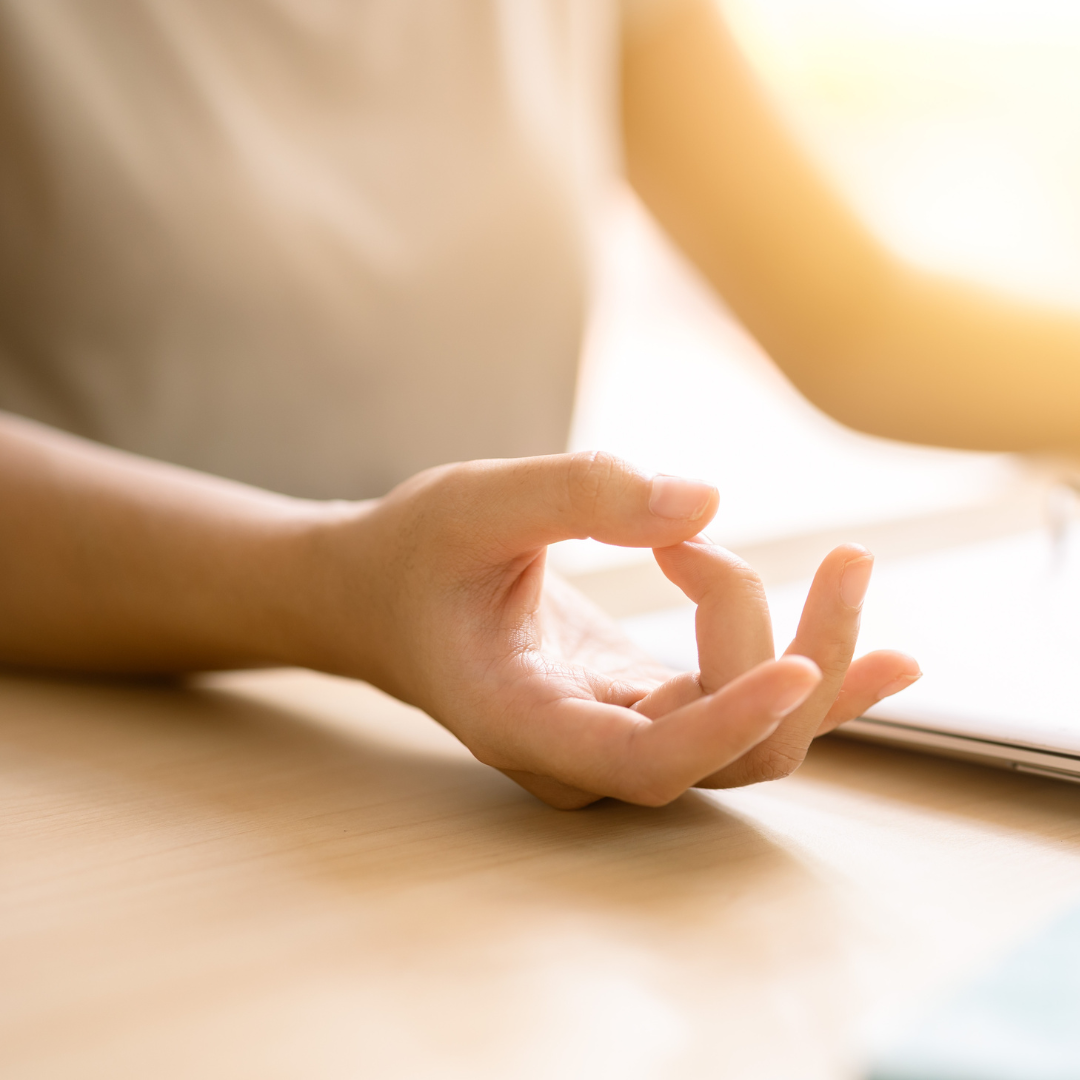Closeup hand doing yoga concentration relax calm peace for reduce stress increase productivity at work.