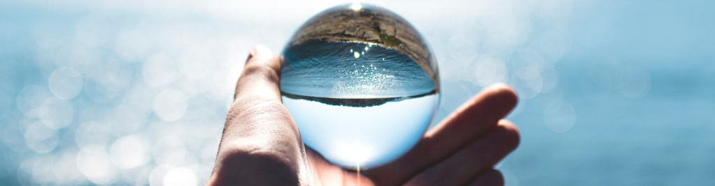 Bokeh Photography of Person Holding Water Drop