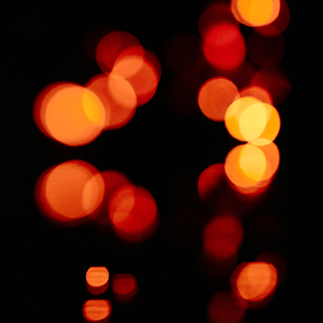 Unfocused blur orange light dots on black background