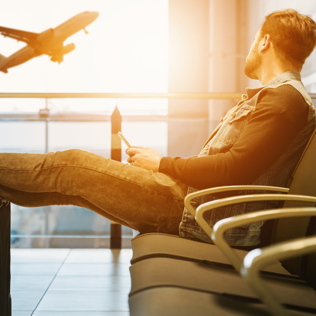 Man in airport waiting for boarding on plane