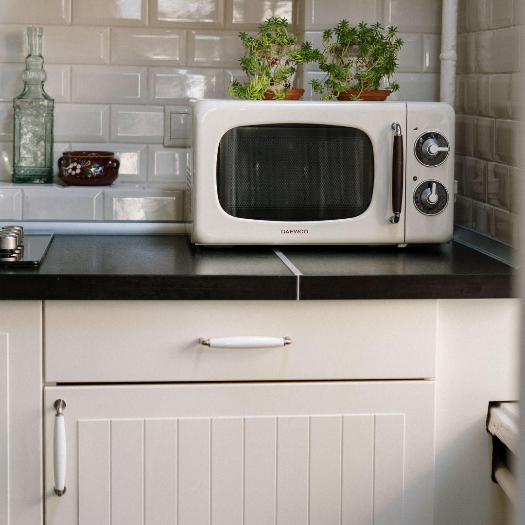 Silver Microwave Oven on White Wooden Cabinet