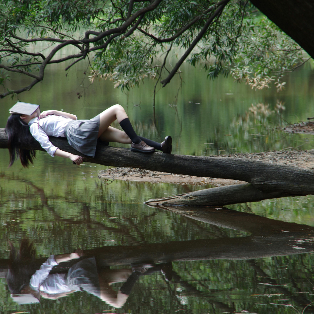 Woman Lying on Tree Near Awter