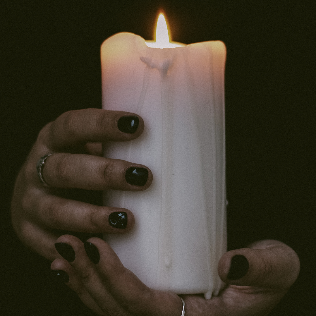 A Close-Up Shot of a Person Holding a Lighted Candle