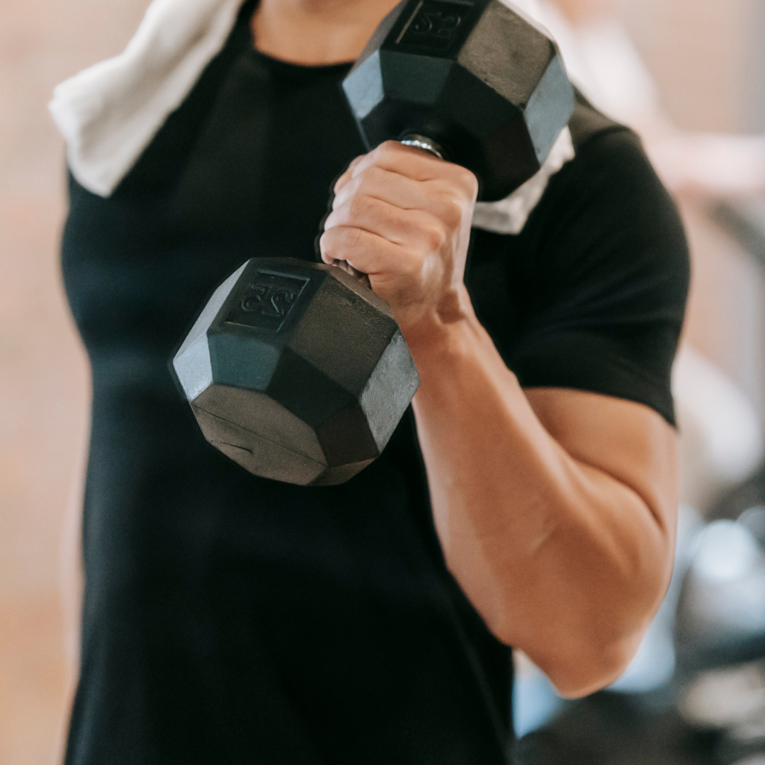 Crop man doing weightlifting workout in gym