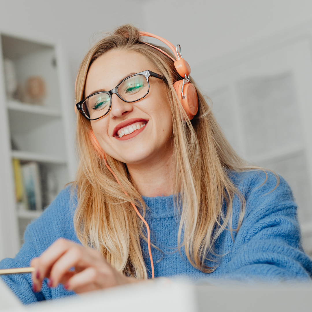 A Woman Smiling using Laptop