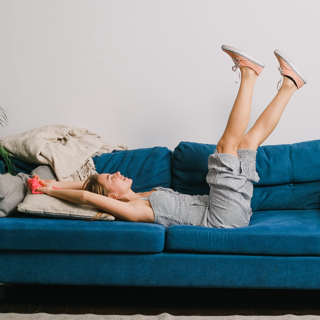 Smiling Homemaker Relaxing on Living Room Couch