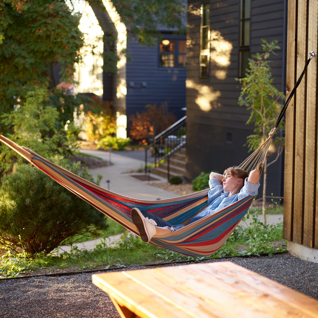 Carefree woman sleeping in hammock in nature