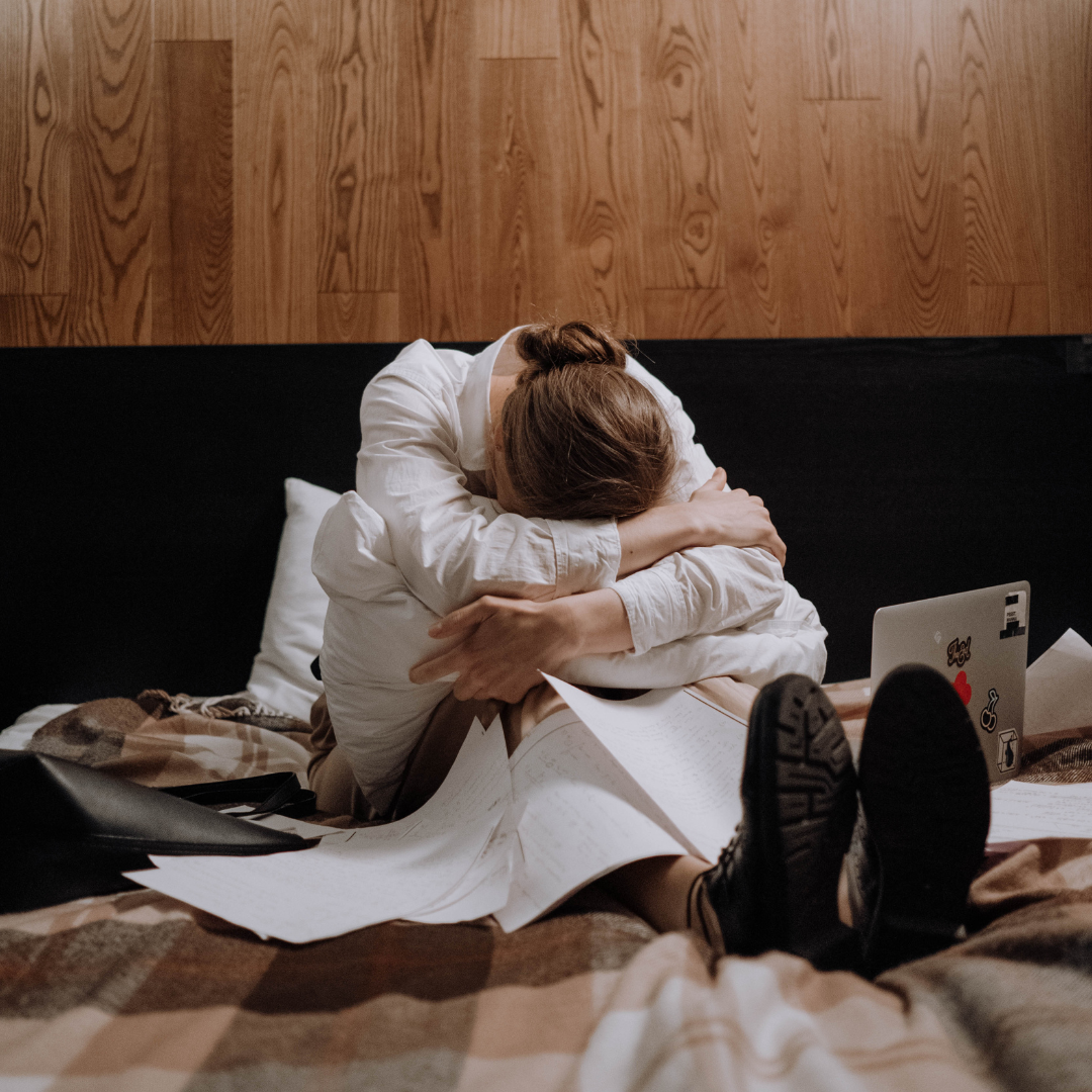 Tired Woman Sitting on the Bed