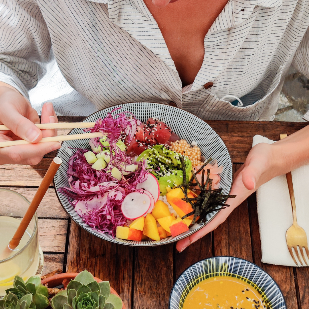 Woman Eating Vegetable Meal Using Chopsticks