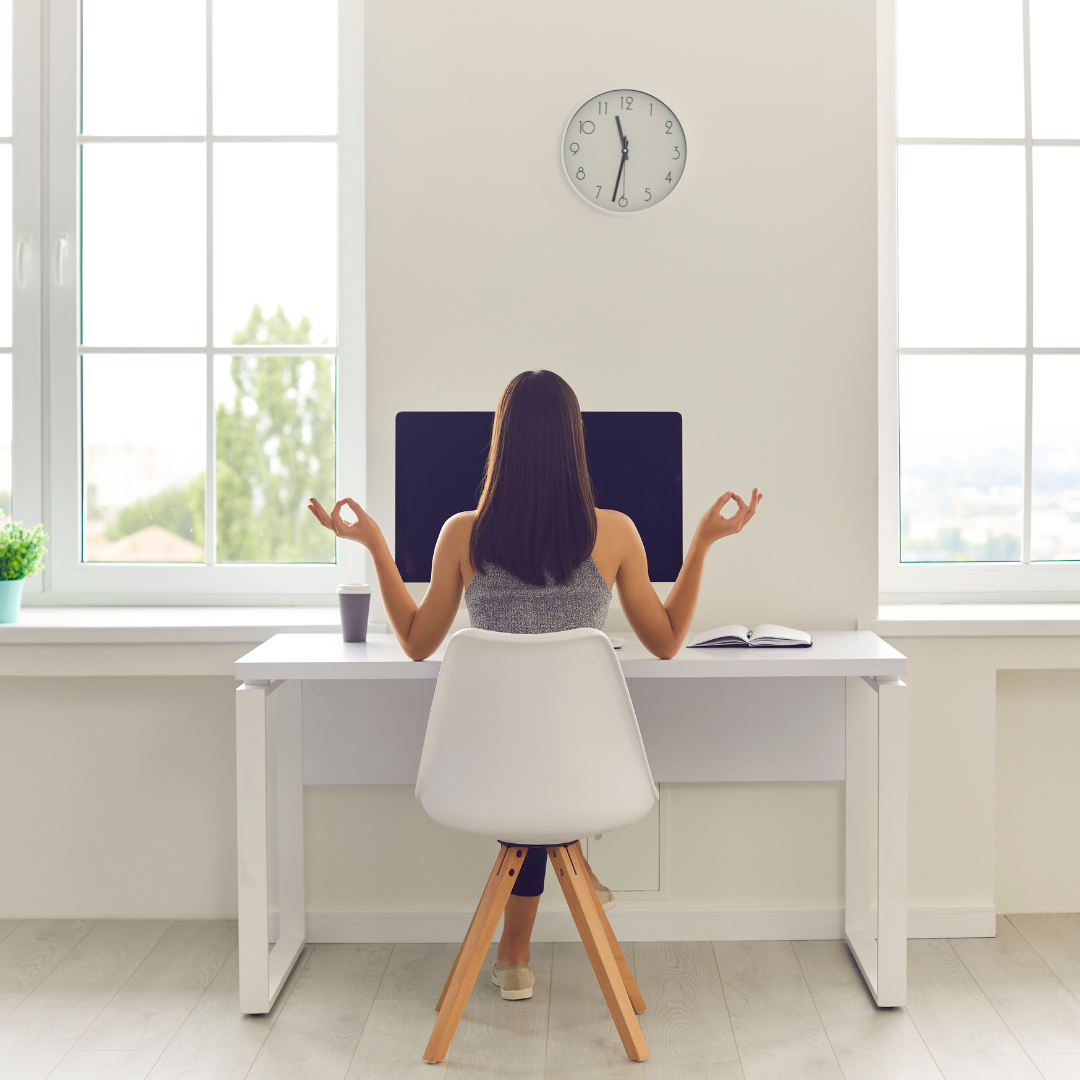 Woman Taking Break from Work and Meditating Sitting at Office Table with Computer and Coffee