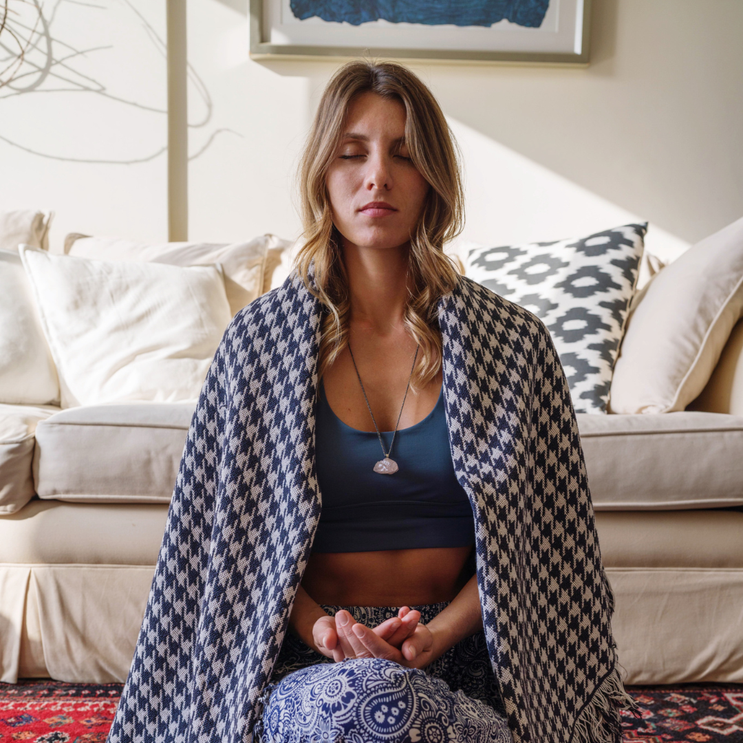 Woman Wearing Crystal Necklace Meditating with Blanket