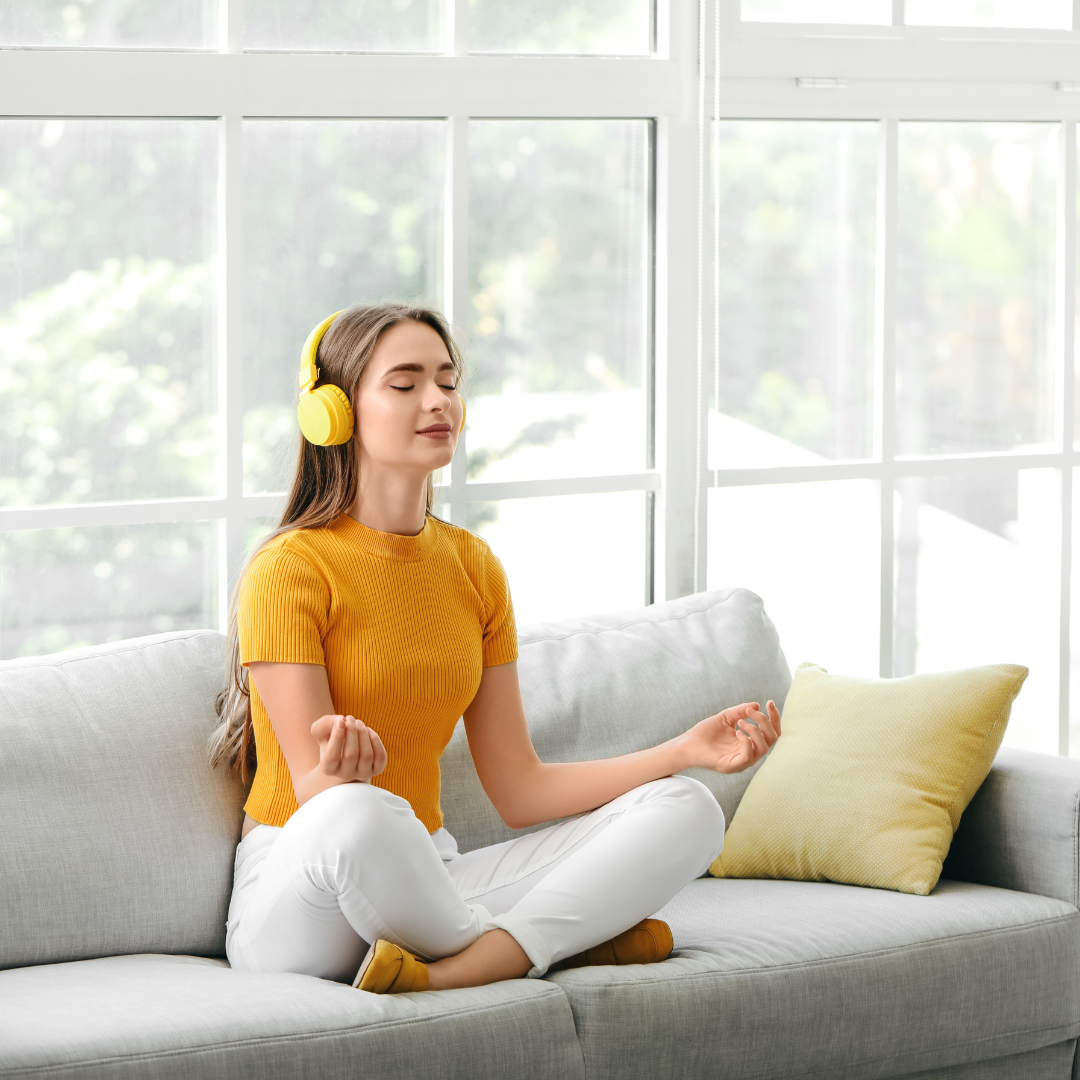 Young Woman Listening to Music While Meditating at Home