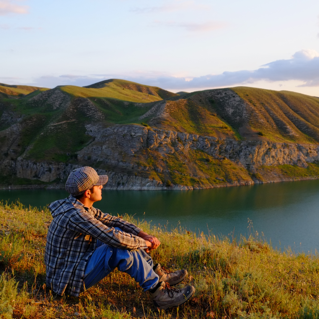 Man Sitting on Grass Field