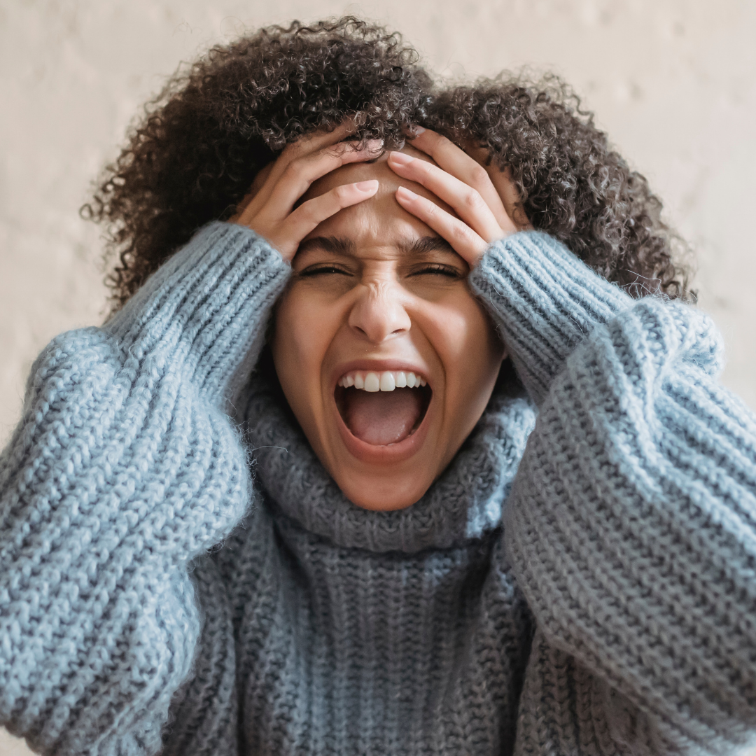 Upset ethnic woman screaming in room