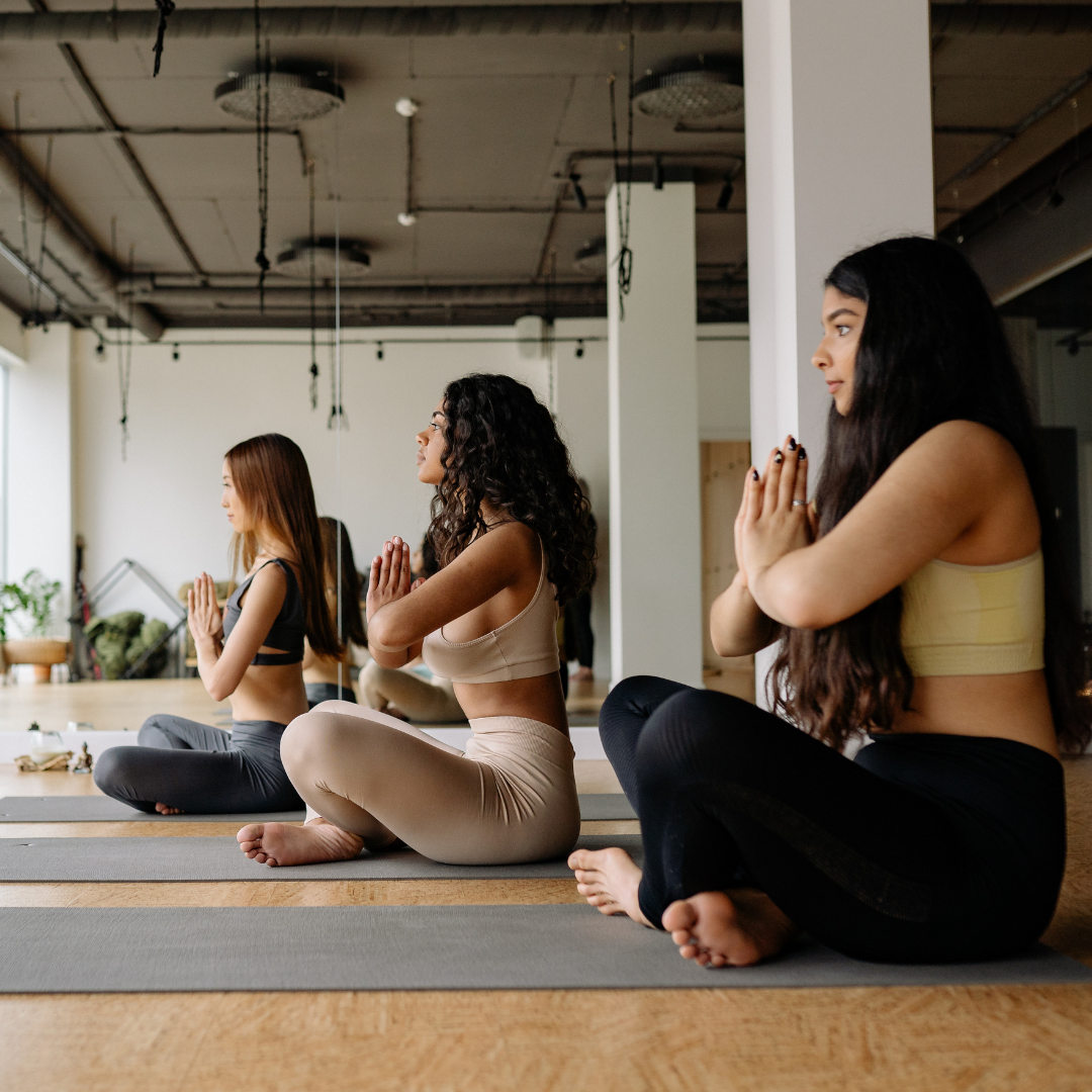 Three Women Meditating in a Yoga Class