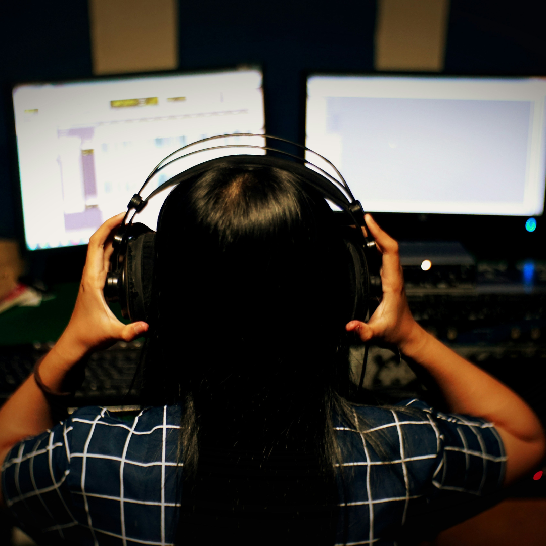 woman in black and white plaid shirt using black headphones