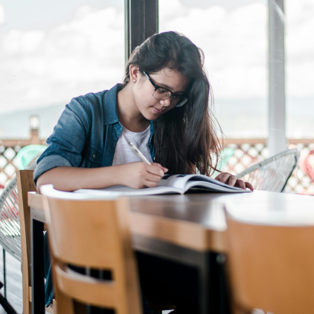 woman writing on book