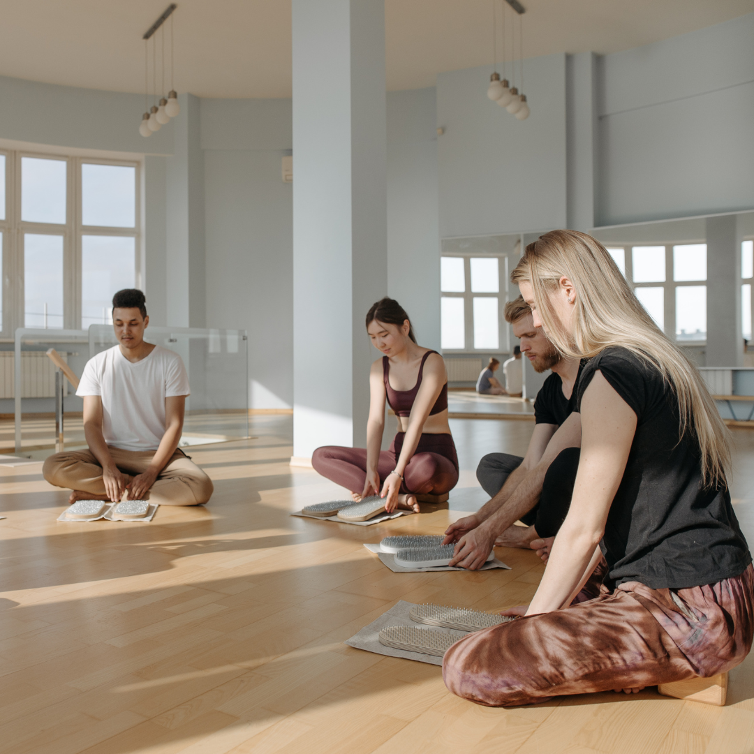 Group of People Sitting on Brown Wooden Floor
