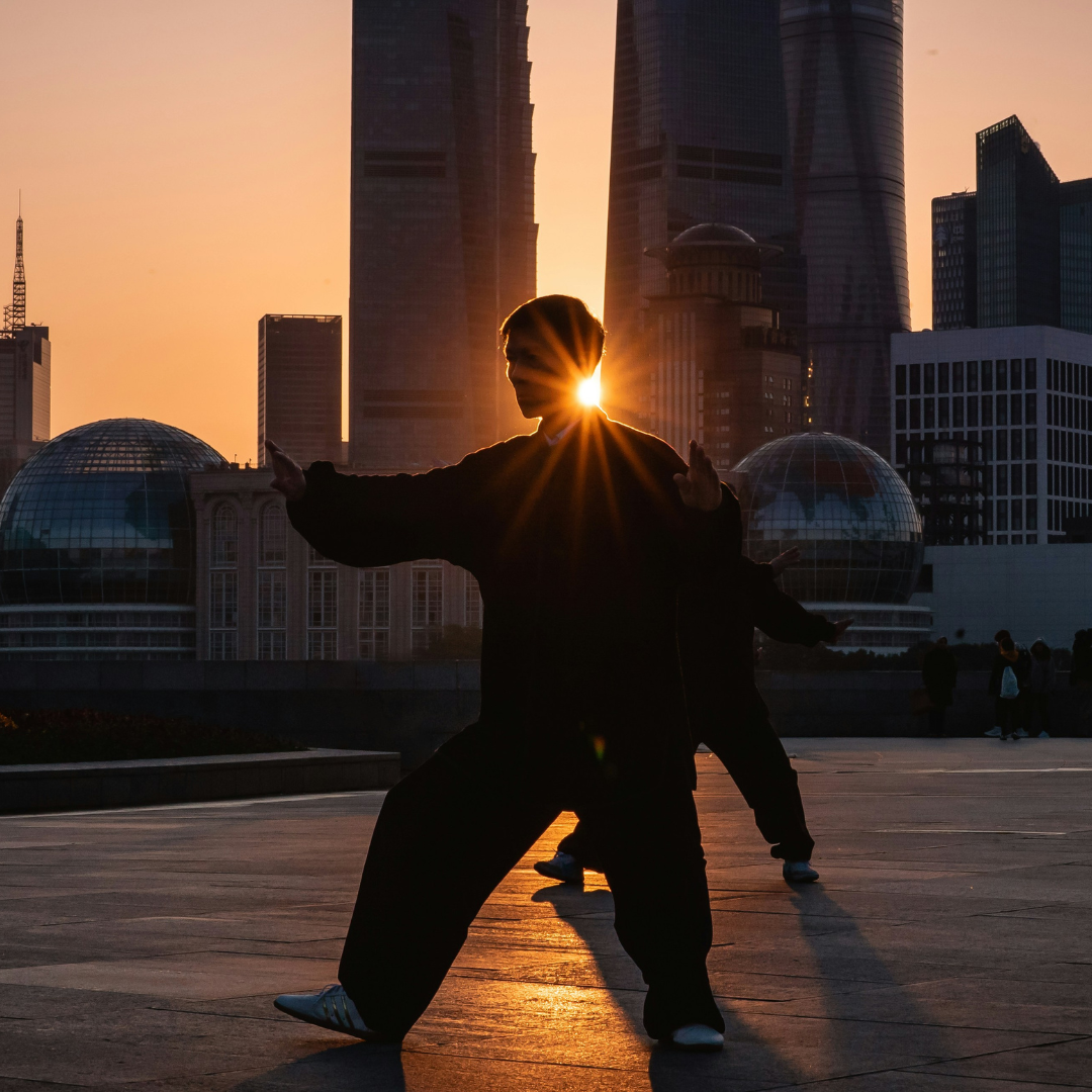 A couple of Tai Chi masters welcome the new day against the Lujiazui skyline in Downtown Shanghai