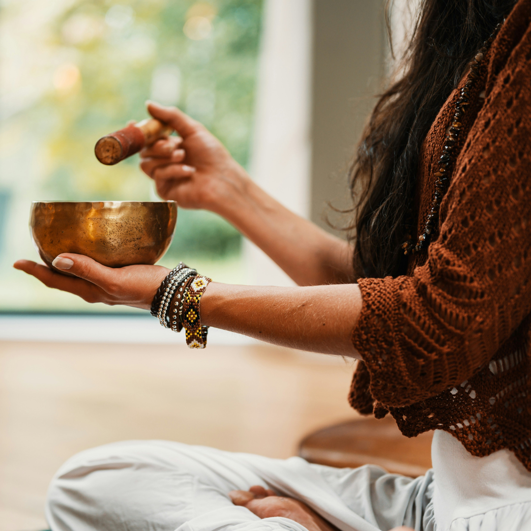 woman in brown knit sweater holding brown ceramic cup