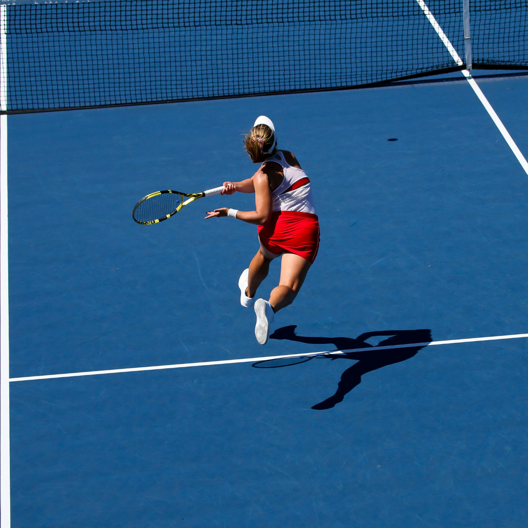 a female tennis player in action on the court