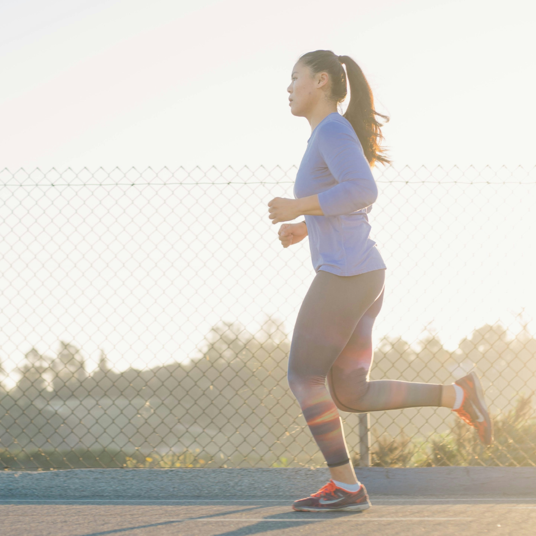 woman jogging near wire fence