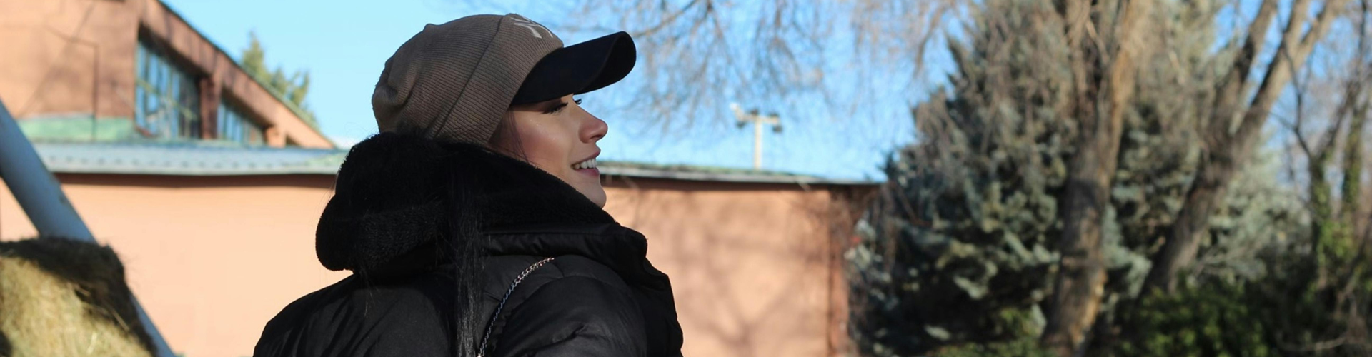 A Woman Wearing a Black Jacket and Cap
