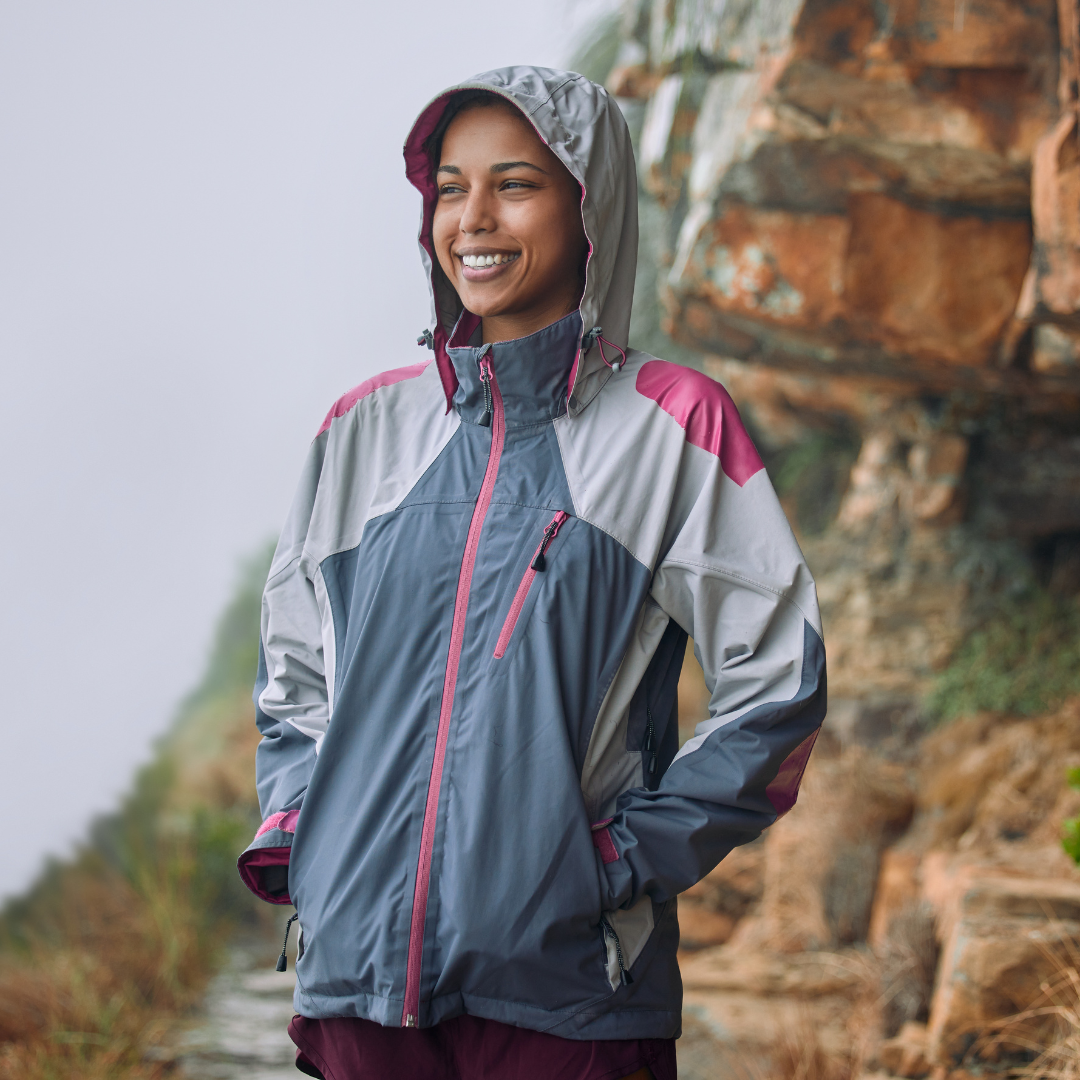 Shot of a woman wearing her rain jacket while out hiking
