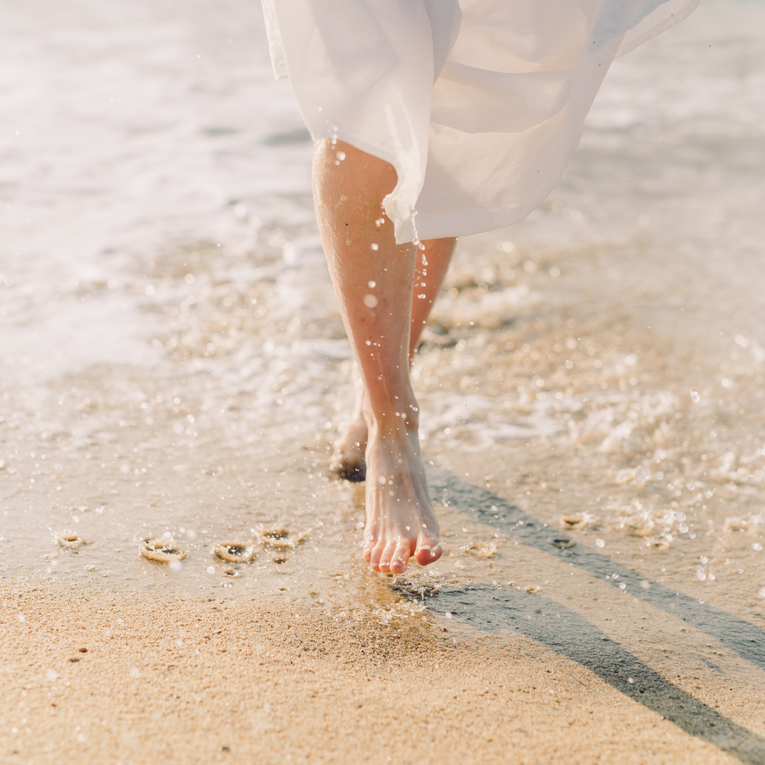 Woman in White Dress Walking on Beach