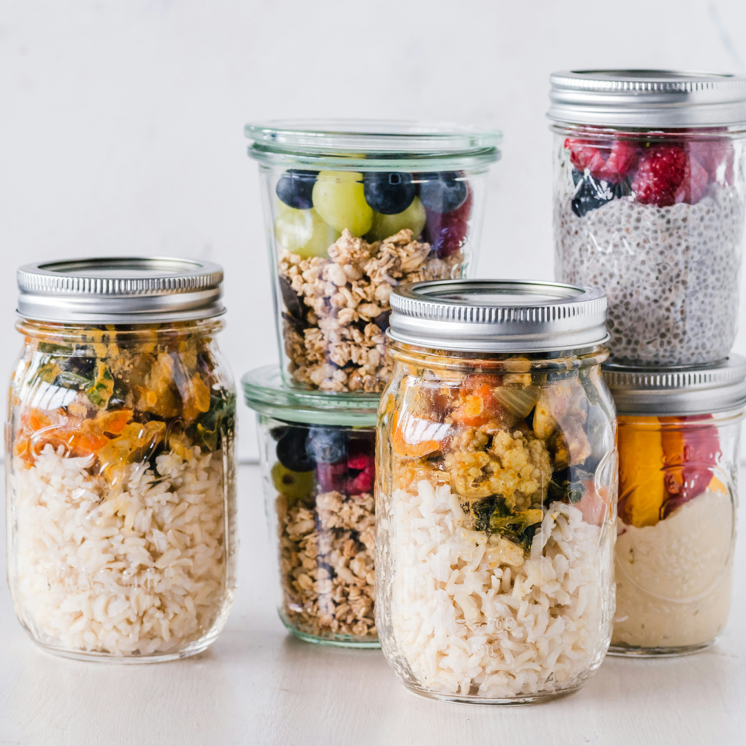 six full clear glass jars on white surface