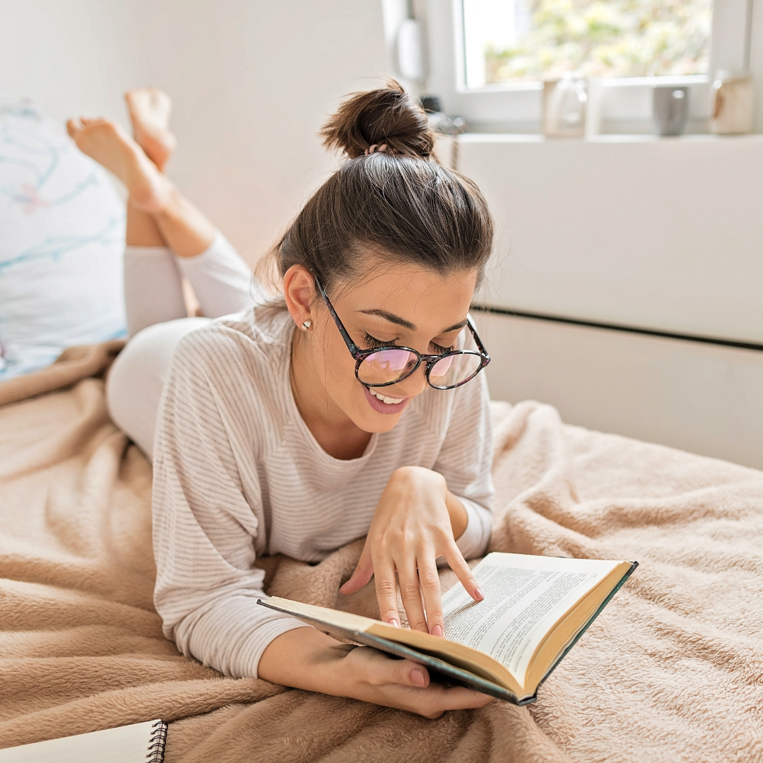 Woman reading book in bed