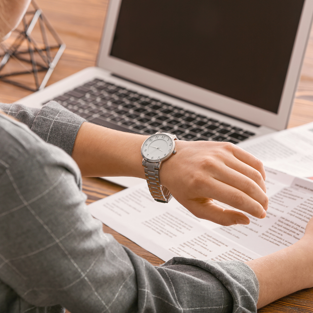 Woman Looking at Her Watch While Working