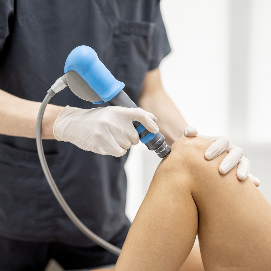 Doctor Applies Shock Wave Therapy on Patient's Knee