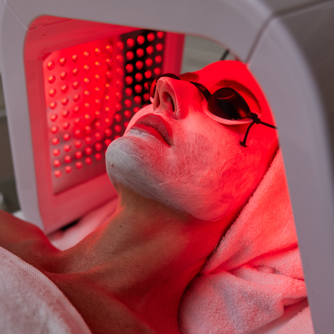 Woman getting facial treatment with led therapy.