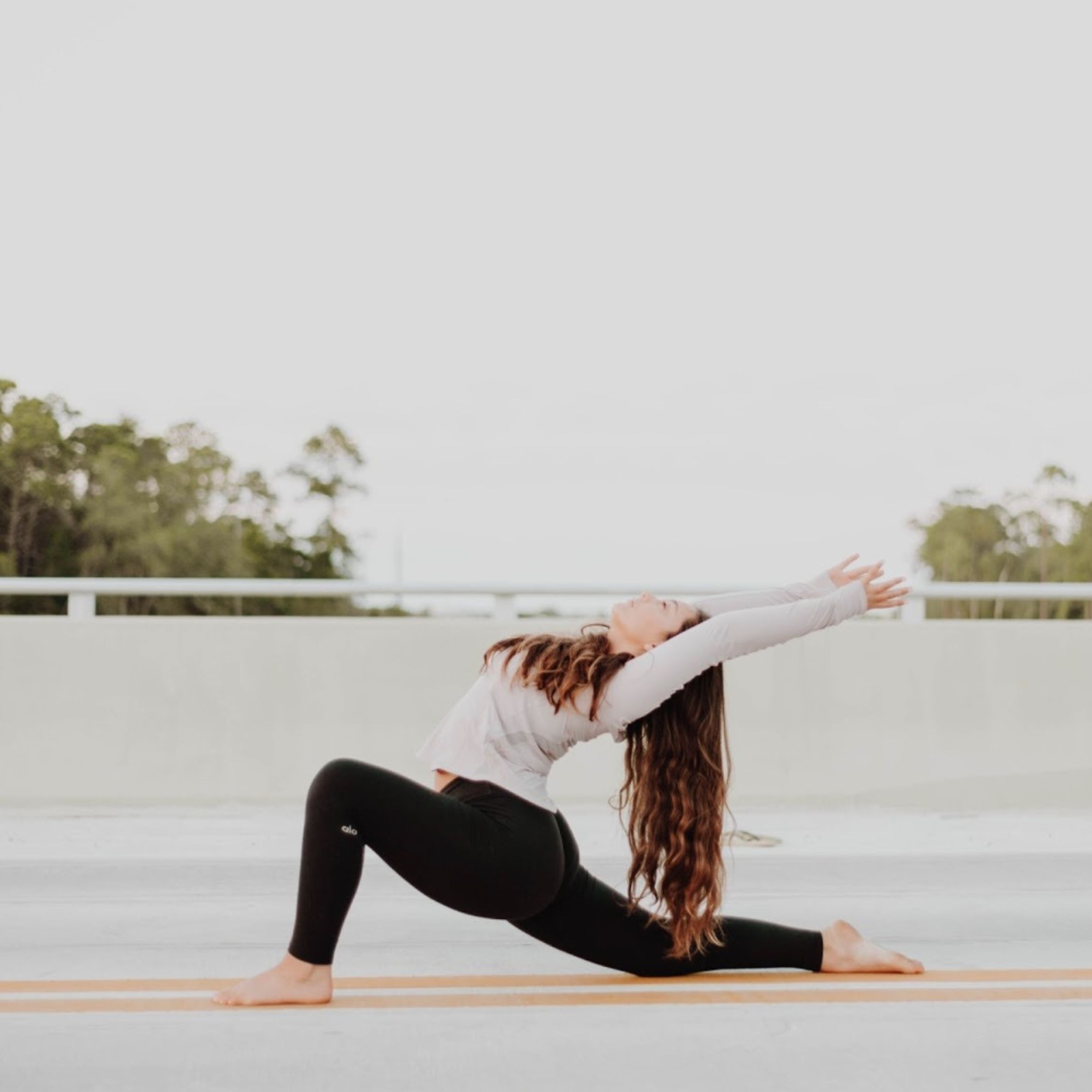 Woman practicing yoga outdoors, symbolizing balance, openness, and energetic alignment