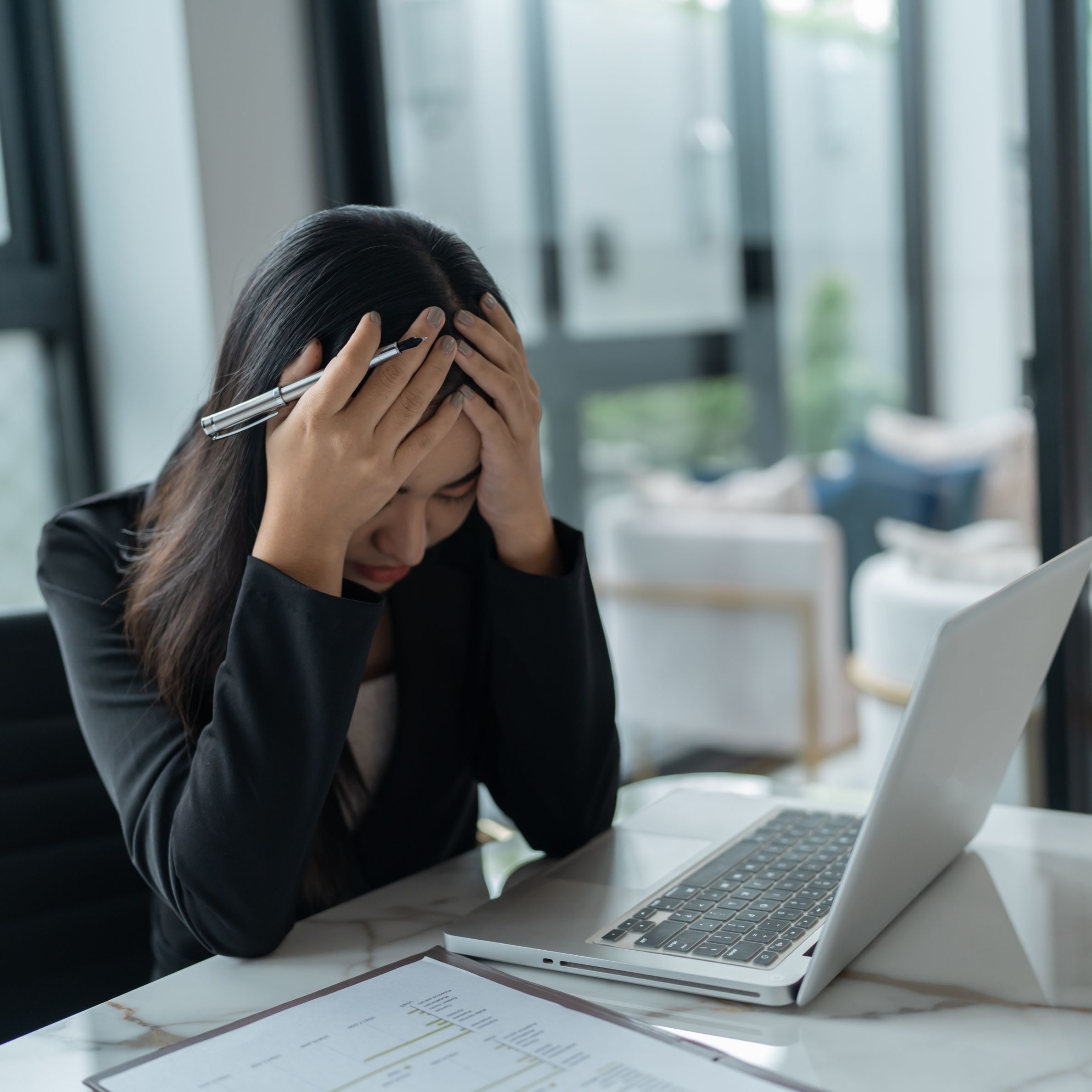 Burnout concept. Asian Business woman touching forehead having headache